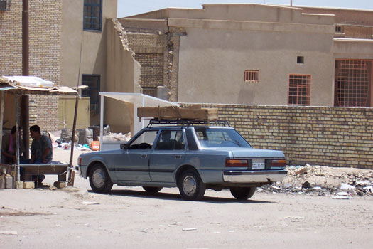 Yet another car carrying a coffin approaches the Baghdad Morgue.